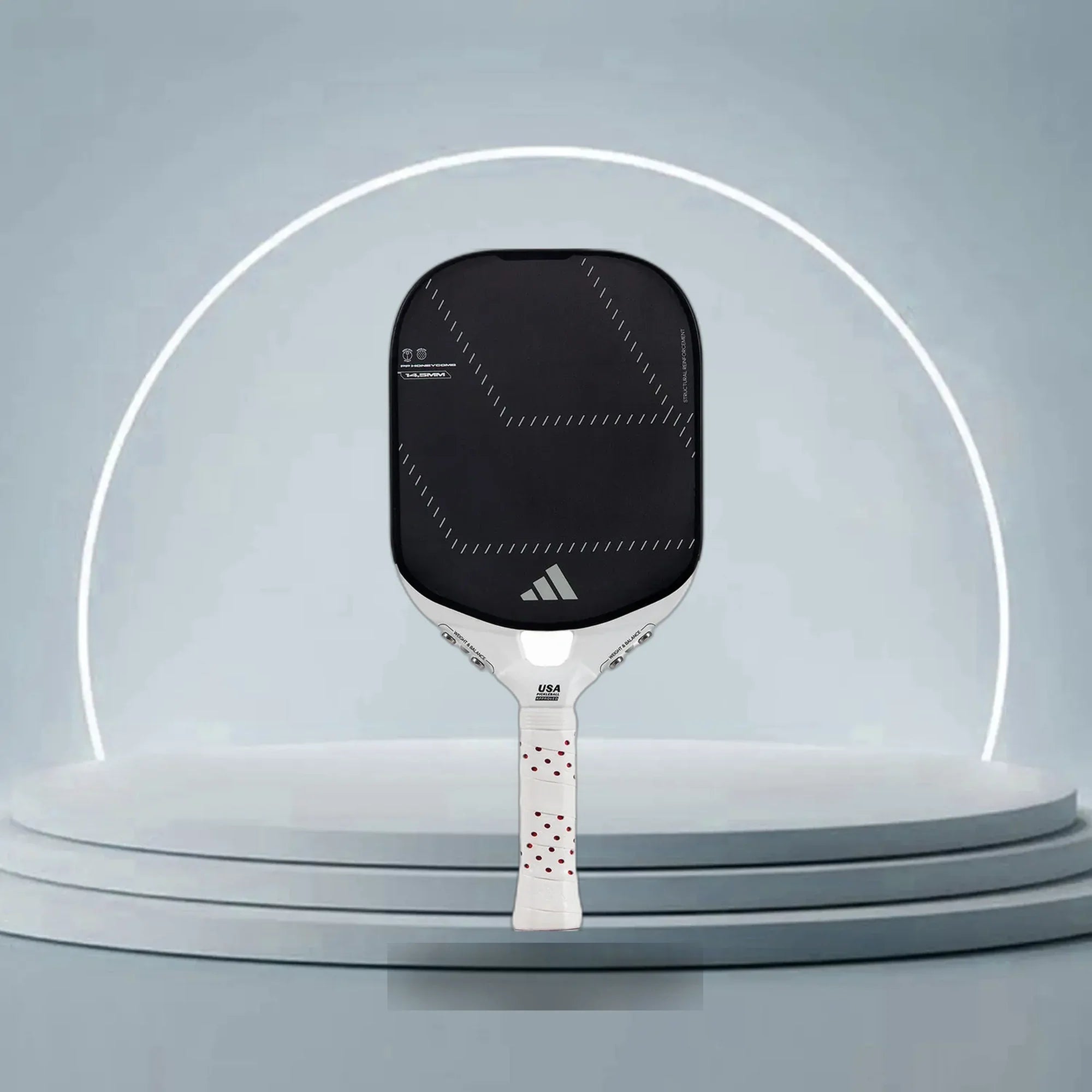 A vibrant Adidas pickleball paddle displayed on a court