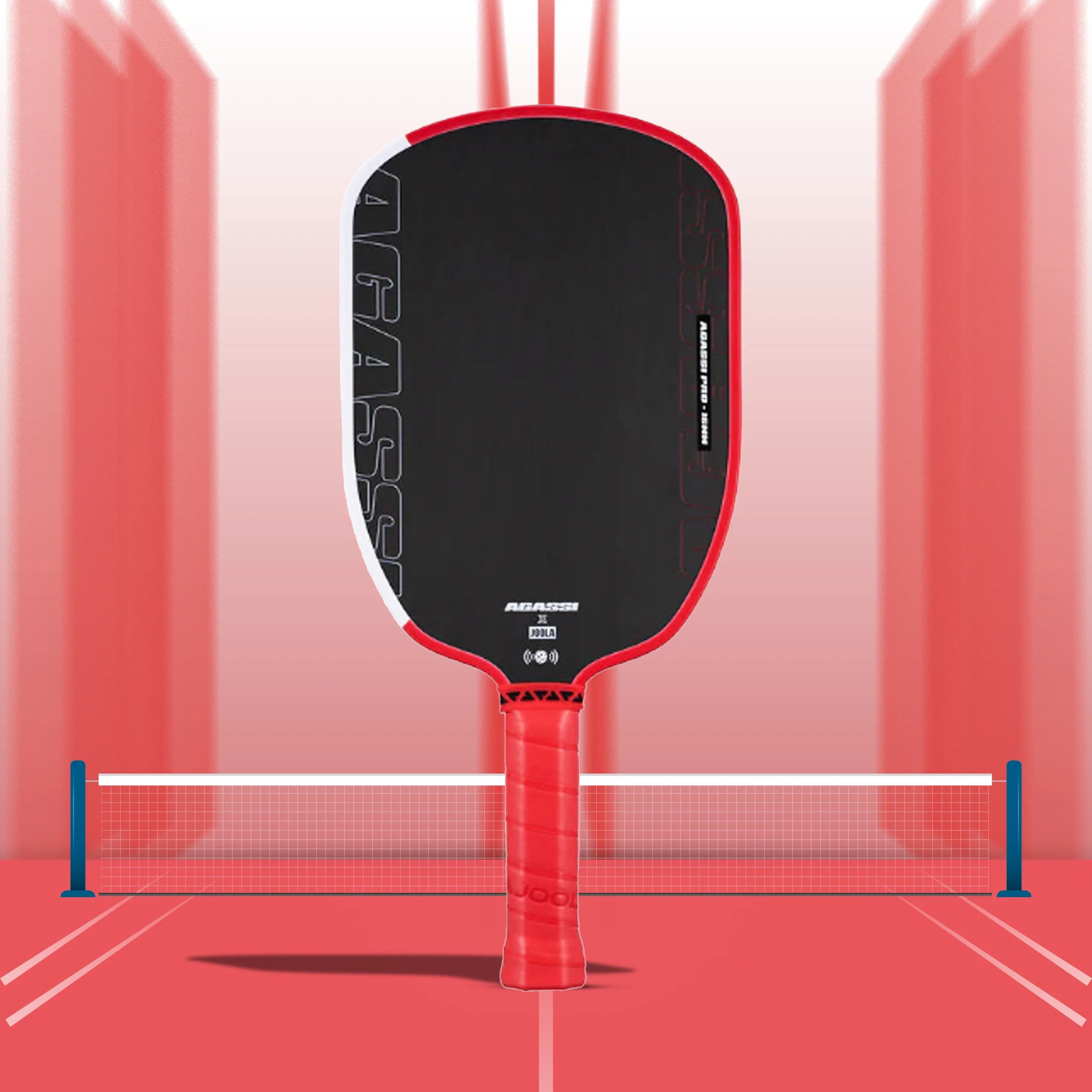 Joola Agassi Pro Pickleball Paddle - 14mm with textured carbon fiber and red Feel-Tec grip on a white background.