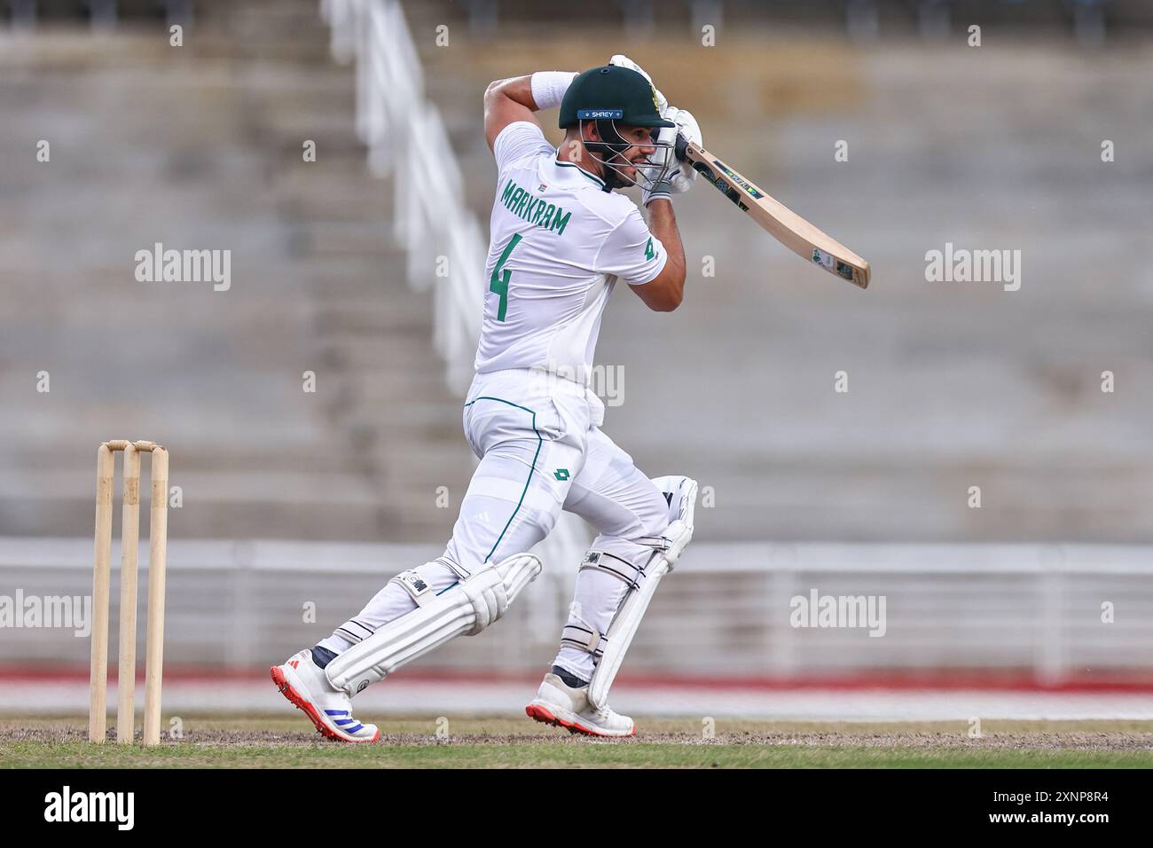 Ben Stokes executes a graceful cover drive in a cricket match against Australia